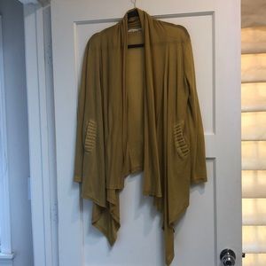 Shrug with embellished pockets, lightly worn.